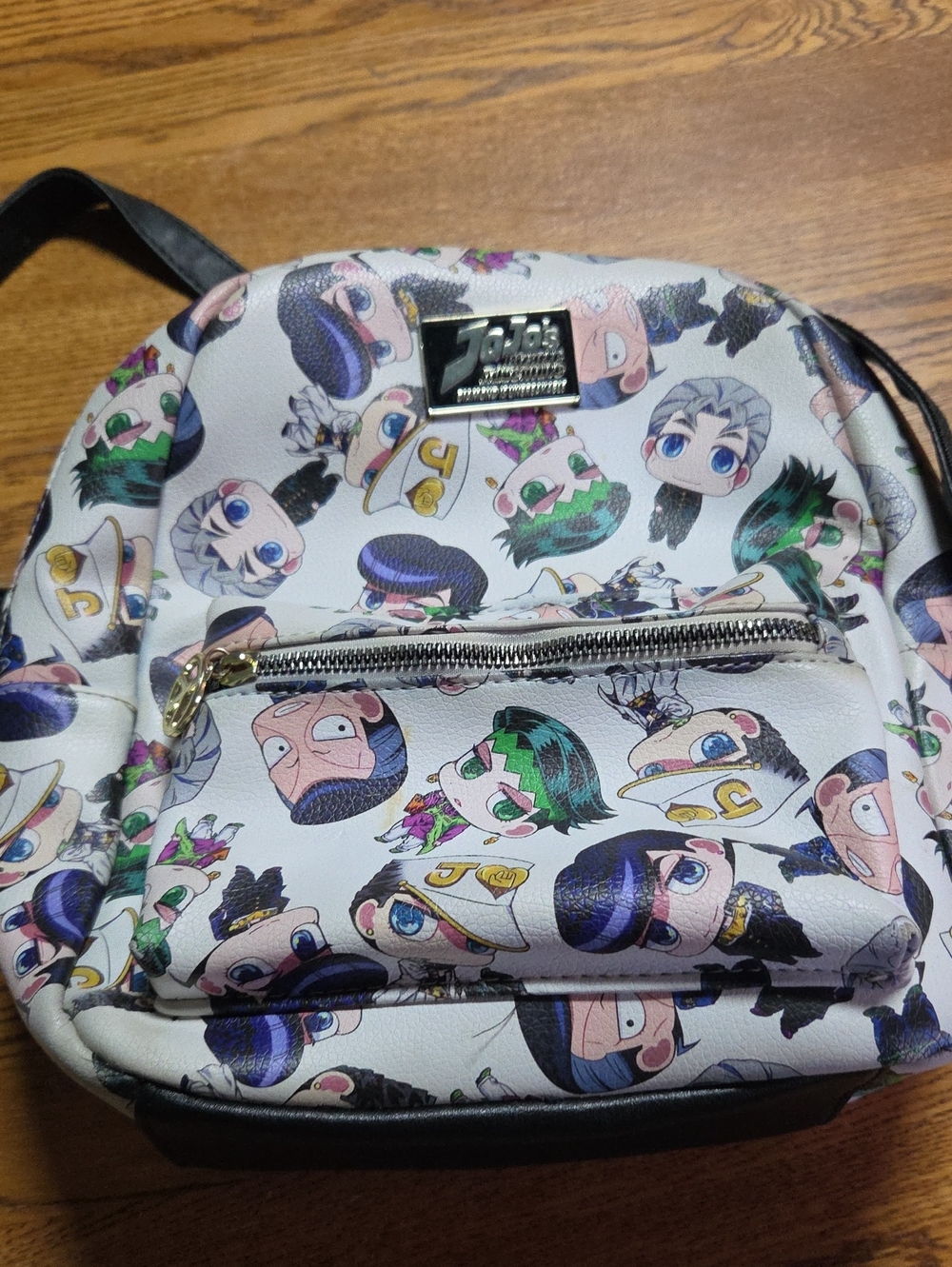 This is a Loungefly mini backpack featuring a "JoJo's Bizarre Adventure: Diamond